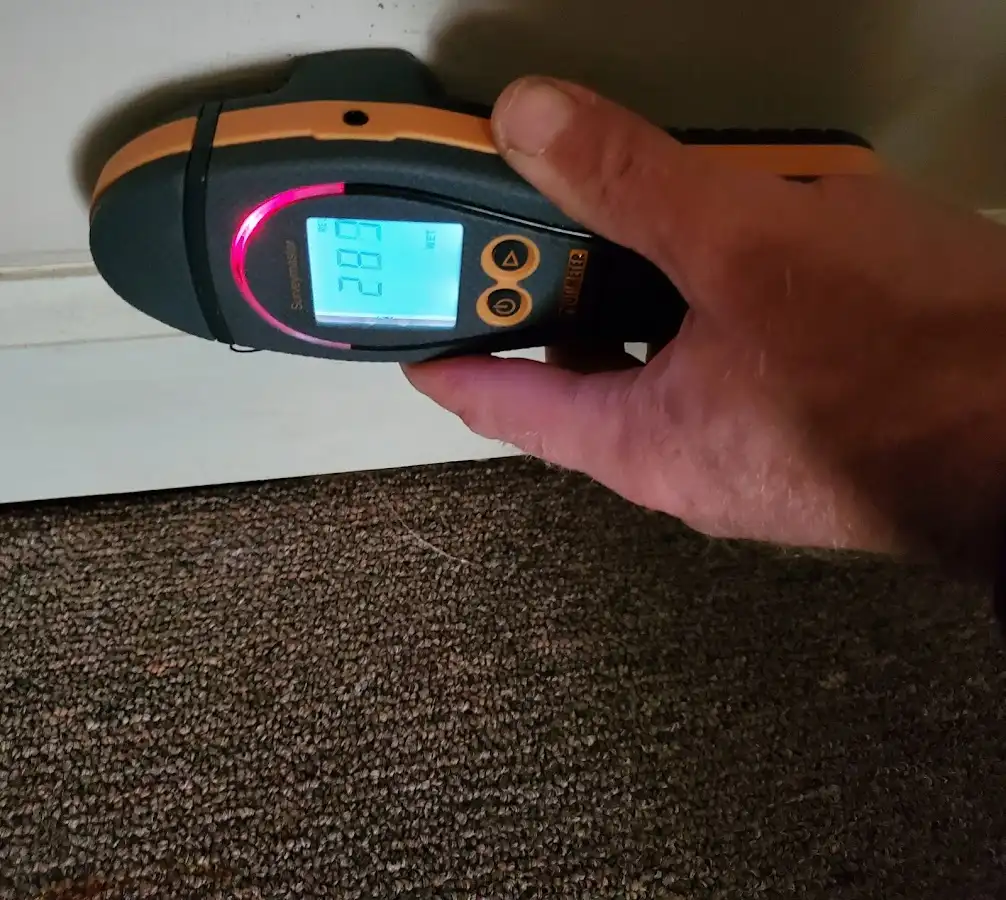 Moisture detection at baseboard during Storm Damage Restoration in Laconia